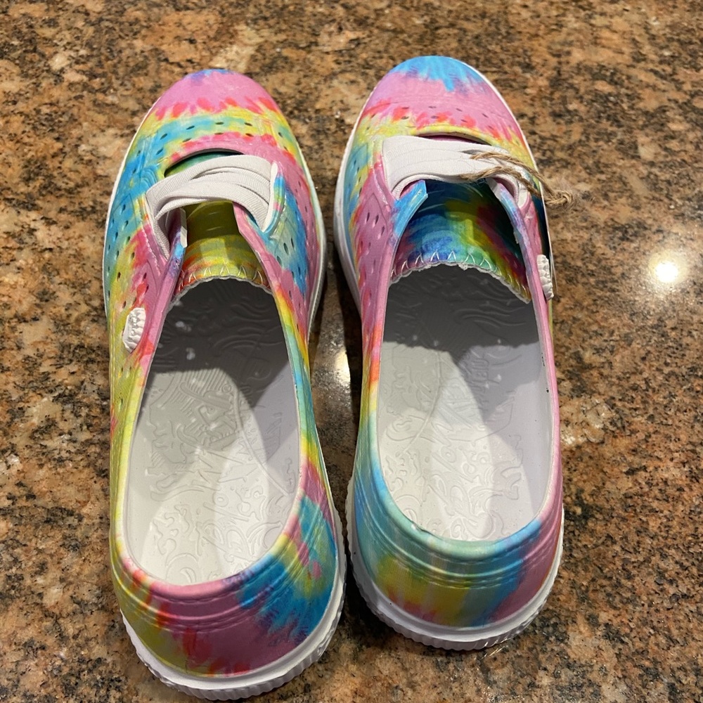 Brand new slip on water proof sneakers. Youth size 4